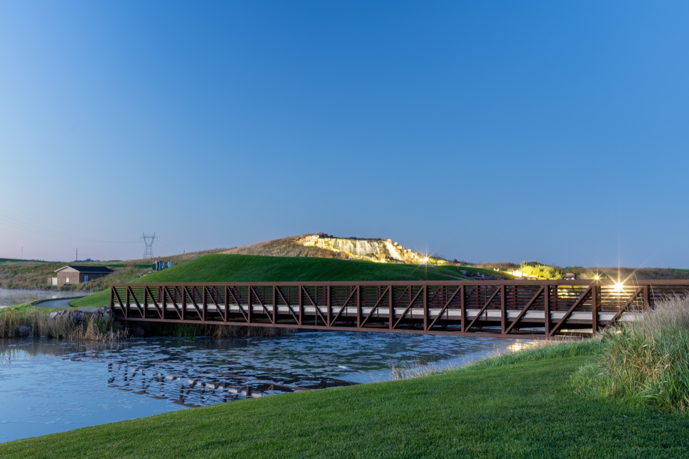 Landscaped grounds with a bridge over a calm pond
