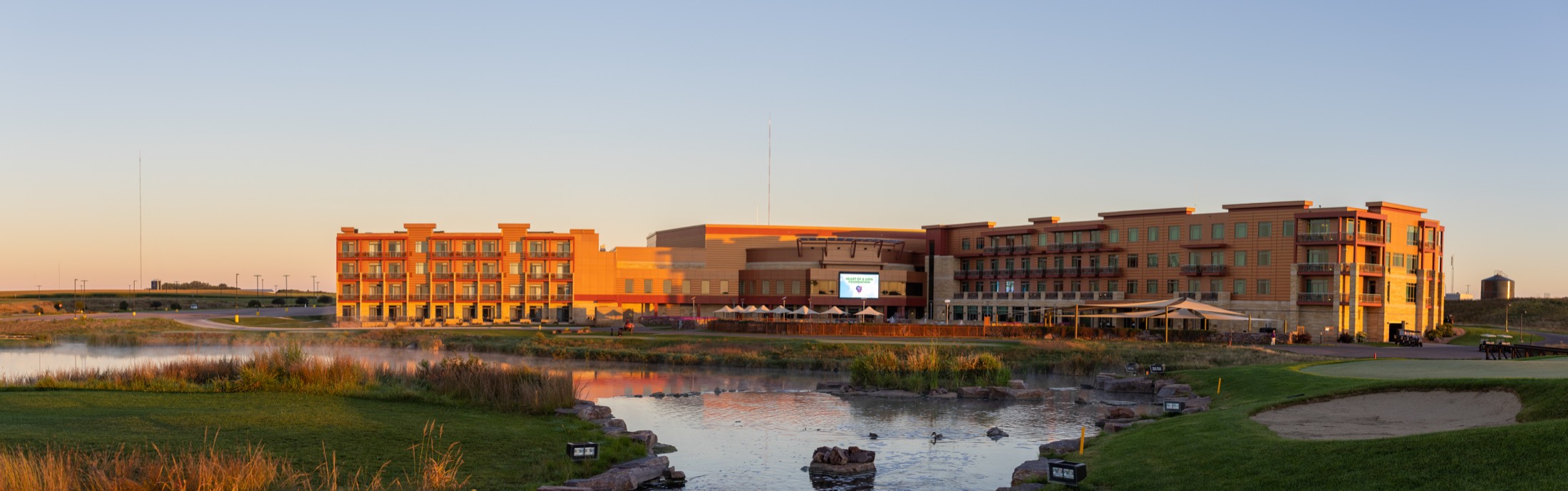 Panoramic view of landscaped resort grounds at dusk