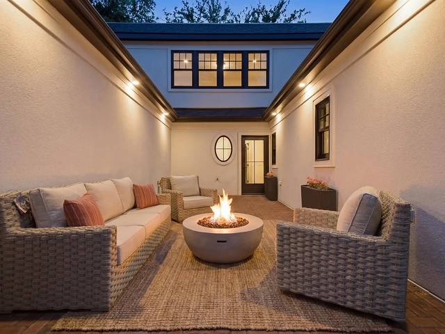 Covered outdoor living space with a gas fire pit and lounge seating